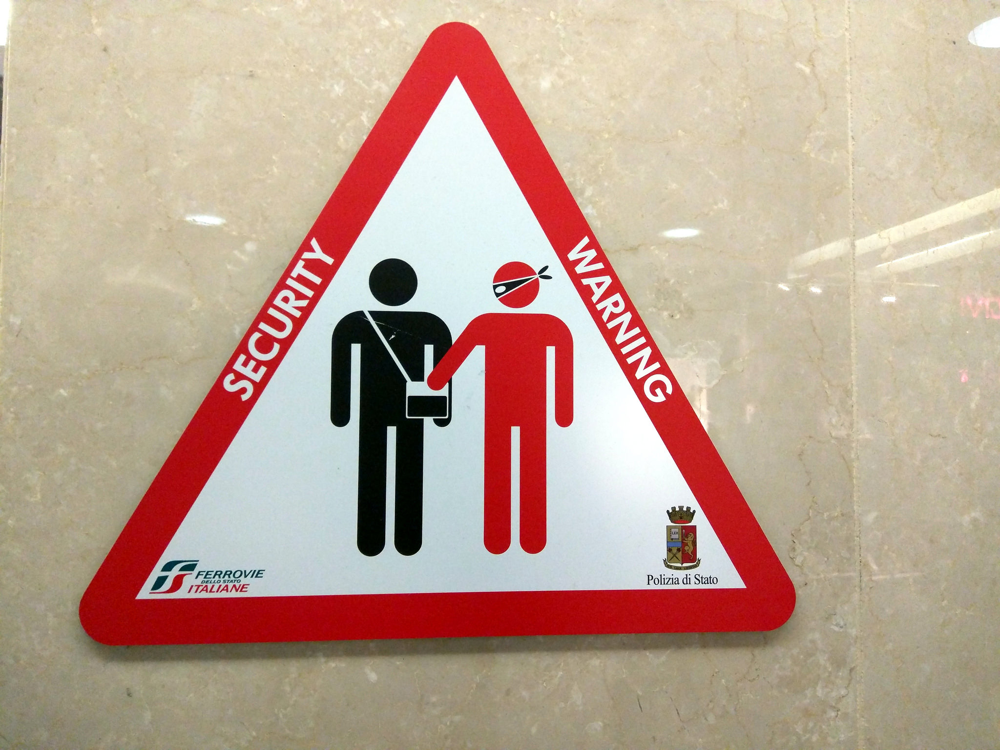 Pickpocket warning sign, train station, Turin, Italy